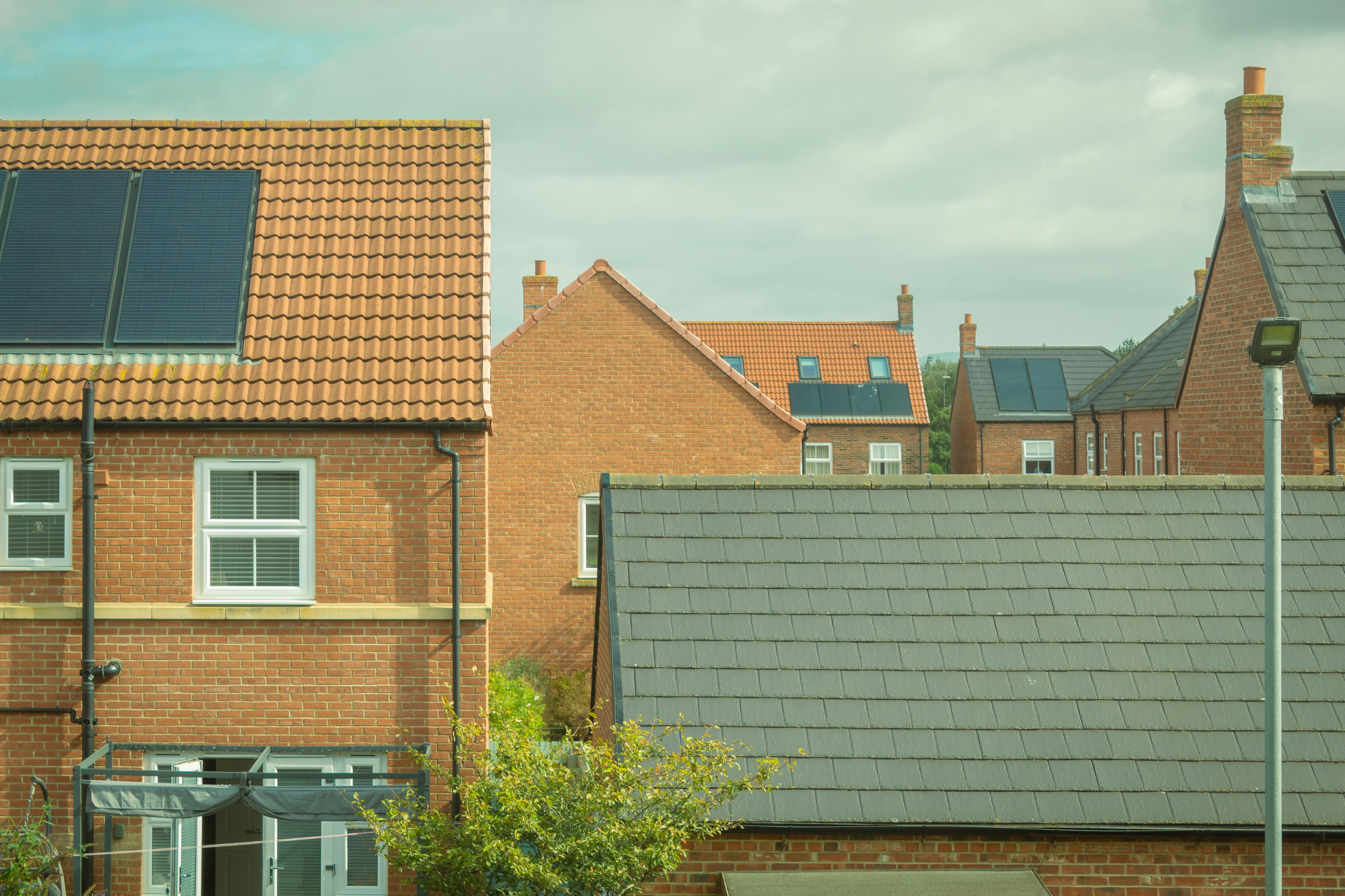 Houses with solar panels are shown in the image